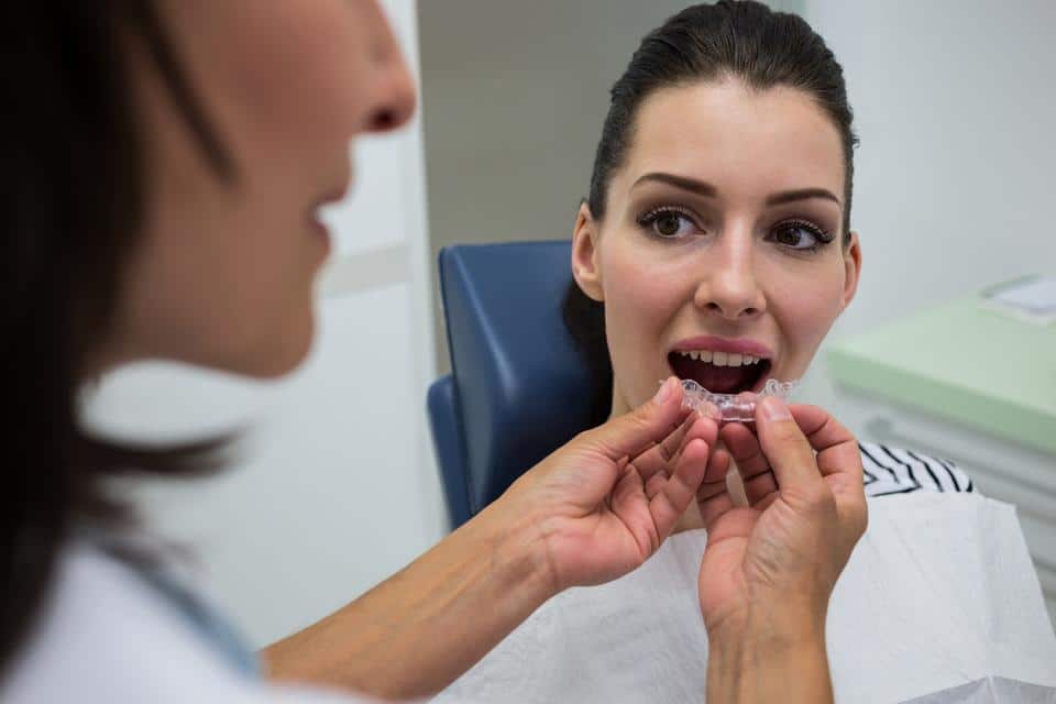 dentist-assisting-female-wear-invisible-mouthguards Elevating Community Safety: Enspire Dental’s Complimentary Athletic Mouthguard Clinics for Ann Arbor Teams